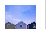 Beach huts in a row against sky by Assaf Frank